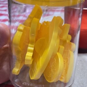 Yellow Plastic Tokens in Jar